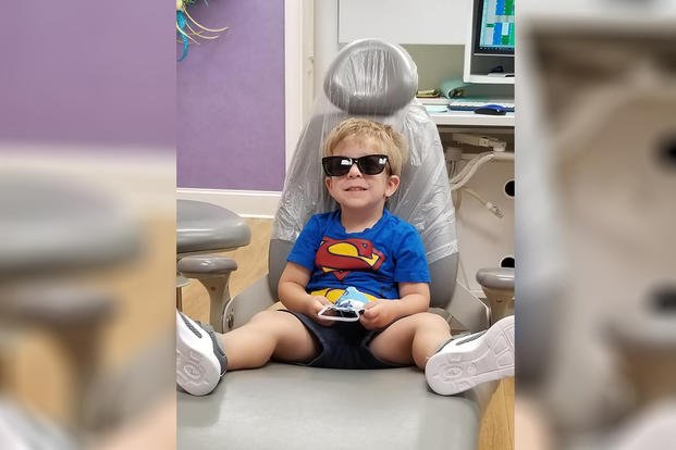 child sitting in dentist chair